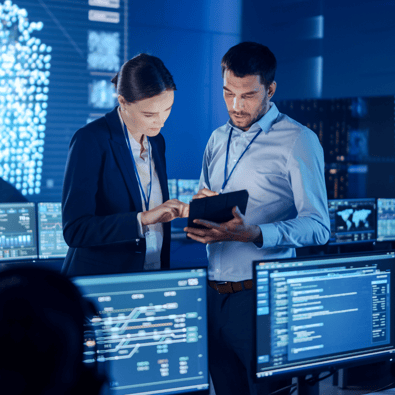 Two people talking about cyber security in a cyber lab